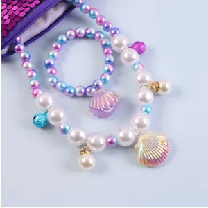 Children mermaid pearl necklace bracelet set close up detail, colorful shell pendant cute styling.
