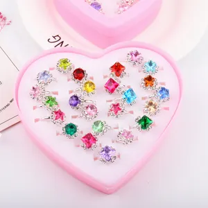 Close up detail showing colorful rhinestone adjustable rings inside a cute pink heart box.