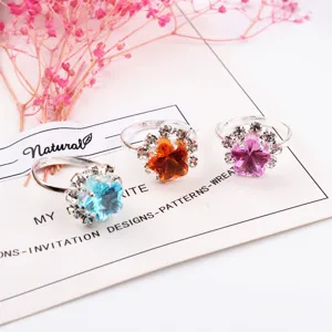 Detailed view of adjustable children rhinestone rings featuring sparkling crystal floral designs.
