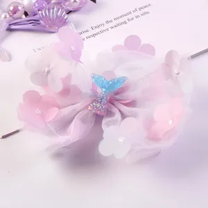 Children's cute purple mesh hair bow with sparkling mermaid tail and floral accents for girls.