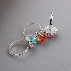 Close-up detail view of adjustable kids rhinestone rings featuring colorful crystal stones.