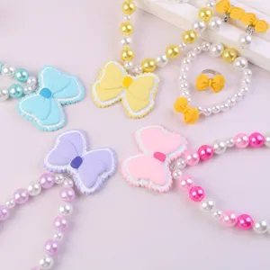 Children cute resin bow pearl necklace bracelet detail close-up view accessories girls