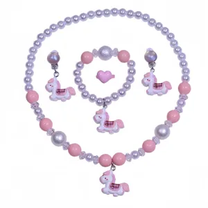 Close-up details of children pink pony beaded necklace bracelet earrings and ring set.