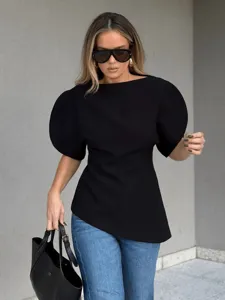Chic slim-fit crew neck puff sleeve black top paired with stylish blue jeans for modern look.