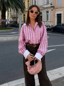 Detail view of the pink striped lapel long sleeve shirt, showcasing casual style and chic design.