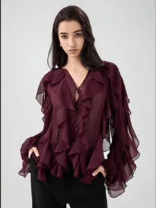 Detailed view of the burgundy ruffle blouse showing the elegant V-neck and layered sleeves.