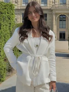 Vue de détail d'un élégant costume de blazer en mélange de lin blanc pour femmes, style.