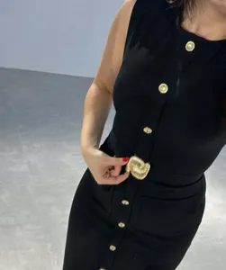 Elegant black sleeveless midi dress featuring striking gold buttons and metal belt buckle