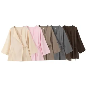 Women linen wrap blouse detail view showcasing multiple color options with elegant side tie design.