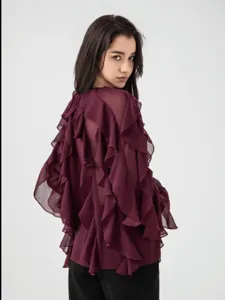 Detail view of women's burgundy sheer long-sleeve blouse with layered ruffle back.