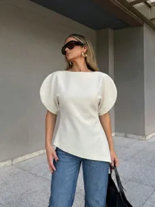 Detail view of a stylish white puff sleeve top showcasing its elegant structure and fine fabric.