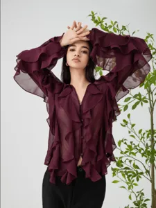 Detailed view of the elegant burgundy V-neck blouse featuring layered ruffles on sleeves.