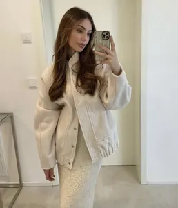Detailed view of women casual off-white textured jacket, stylish daily outfit scene.