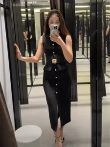 Chic elegant black sleeveless midi dress with gold buttons and stylish belt for women.