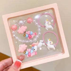 Cute kids jewelry set featuring cute unicorn hair ties and pearl bead bracelet in display box.