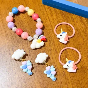 Cute children jewelry set with beaded bracelet, unicorn hair ties and cloud clip-on earrings.