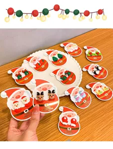 Cute Christmas children clip-on earrings close-up, featuring cartoon Santa and reindeer design.