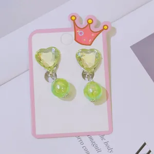Green heart crystal clip-on earrings detail shot showing lovely design for kids non-pierced ears.