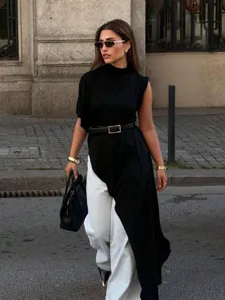 Street style detail of asymmetrical high neck sleeveless top in black color for women.