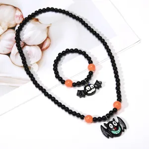 Close-up detail of Halloween black bead necklace and bracelet set with cute bat pendant accessories.