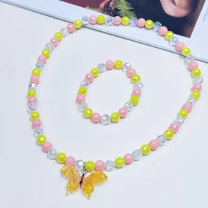 Detailed shot of colorful beaded necklace and bracelet set featuring a cute yellow butterfly pendant.