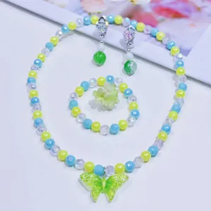 Children fairy style butterfly beaded necklace bracelet earrings ring jewelry detail shot.