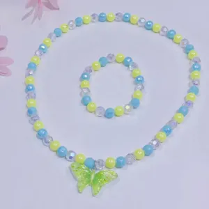 Children's cute beaded necklace and bracelet set with green butterfly pendant accessory.