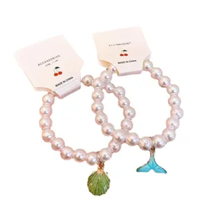 Pearl beaded bracelet with cute shell and fishtail pendants, stylish fashion jewelry for women.