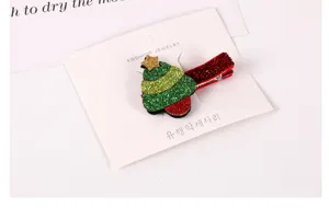 Close-up detail of the cute Christmas tree hair clip with sparkling glitter design for kids.