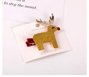 Cute Christmas reindeer hair clip for kids, sparkly gold glitter elk design with red nose.