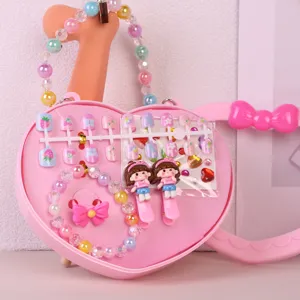 Kids pink heart handbag toy set with press-on nails, beaded bracelet and cute hair clips.