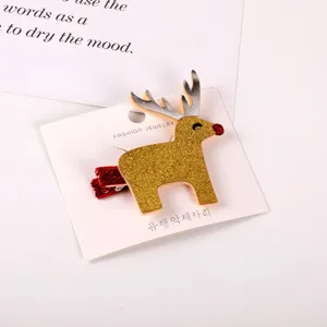 Detail shot of cute Christmas glitter reindeer hair clip with silver antlers and red nose.