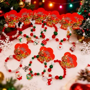 Christmas beaded bracelet detail view, colorful beads with cute cartoon holiday pendants.