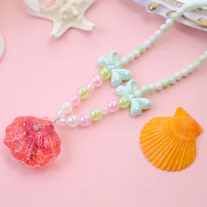 Kids ocean style pearl necklace with pink glitter seashell pendant and cute bow accessories.