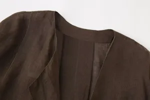 Close up detail of women's dark brown linen top collar and shoulder craftsmanship.