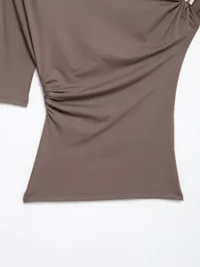 Close-up detail shot of womens asymmetric taupe top showcasing ruched side and metal ring.
