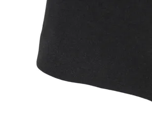 Close-up detail of black fabric texture, showing fine grain surface and curved smooth edge.