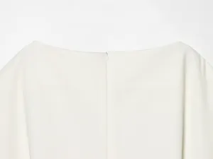 Close-up detail of white women top back neckline and zipper design, premium fabric texture.