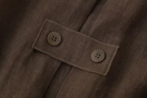 Close-up detail of the brown linen garment featuring a stylish back strap and dual buttons.
