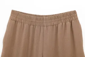 Casual trousers elastic waist detail, comfortable fit, premium drape fabric closeup.