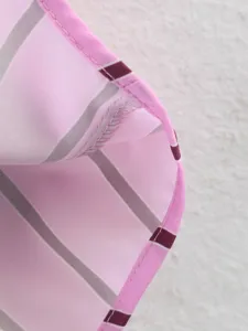 Close-up detail of the stylish pink and grey striped fabric with neat stitching and clean edge finish.