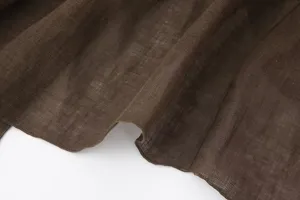 Detailed view of the dark brown linen fabric, showing natural texture, soft drape and close weave.