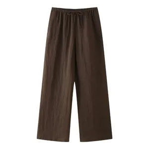 Brown linen drawstring trousers detail view, loose fit casual pants craft and texture display.