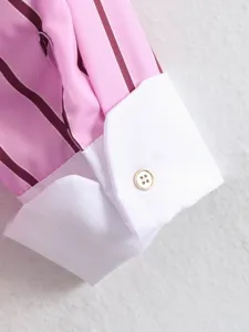 Pink striped long sleeve shirt cuff detail with white contrast cuff and metal button.