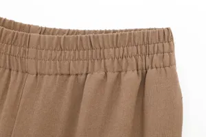Close-up detail of women's casual trousers elastic waistband with neat stitching.