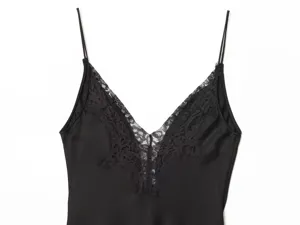 Black satin camisole dress detail, V-neck with elegant black lace trim and thin spaghetti straps.