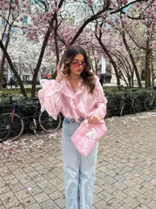 Women's V-neck layered long sleeve pink shirt, chic spring casual apparel detail shot.