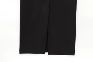 Detailed view of the black midi dress hem with a stylish front slit design for women.
