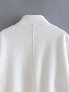 White textured stand collar coat back detail, casual loose outerwear piece close up.