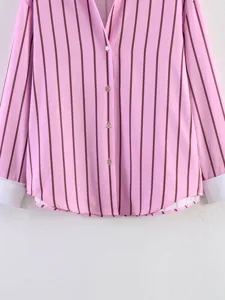 Close-up detail view of women's pink striped lapel shirt featuring long sleeves and cuffs.